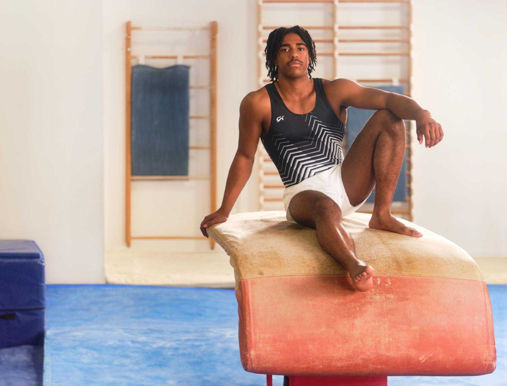 Male gymnast wearing a singlet and shorts