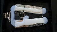a microSD card and board with weights hot glued inside a drive enclosure