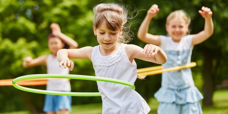 Niñas jugando al hula-hoop.