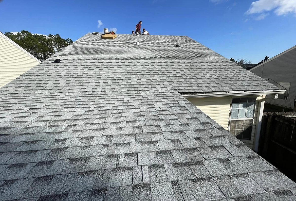 A man standing on top of a roof.