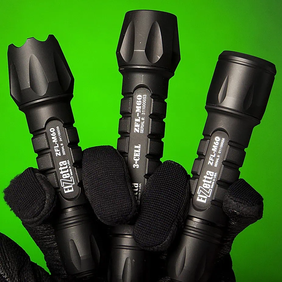 Elzetta FAQ Page Image of Three Bravo flashlights in gloved Hand. Green Background