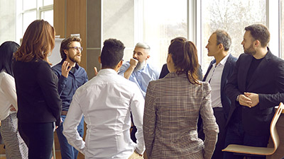 Group listening to a speaker in an office meeting