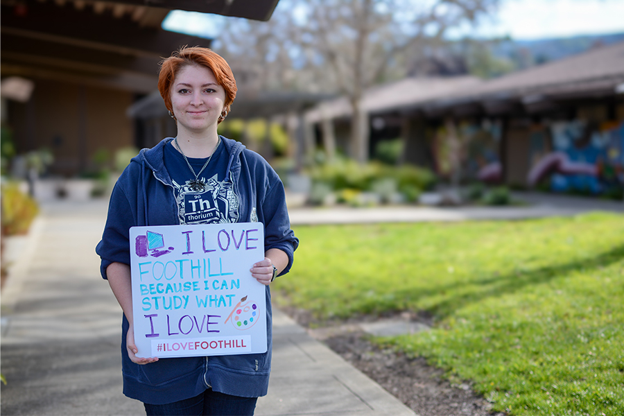 Female student with a sign "I Love Foothill because I can study what I Love #Ilovefoothill