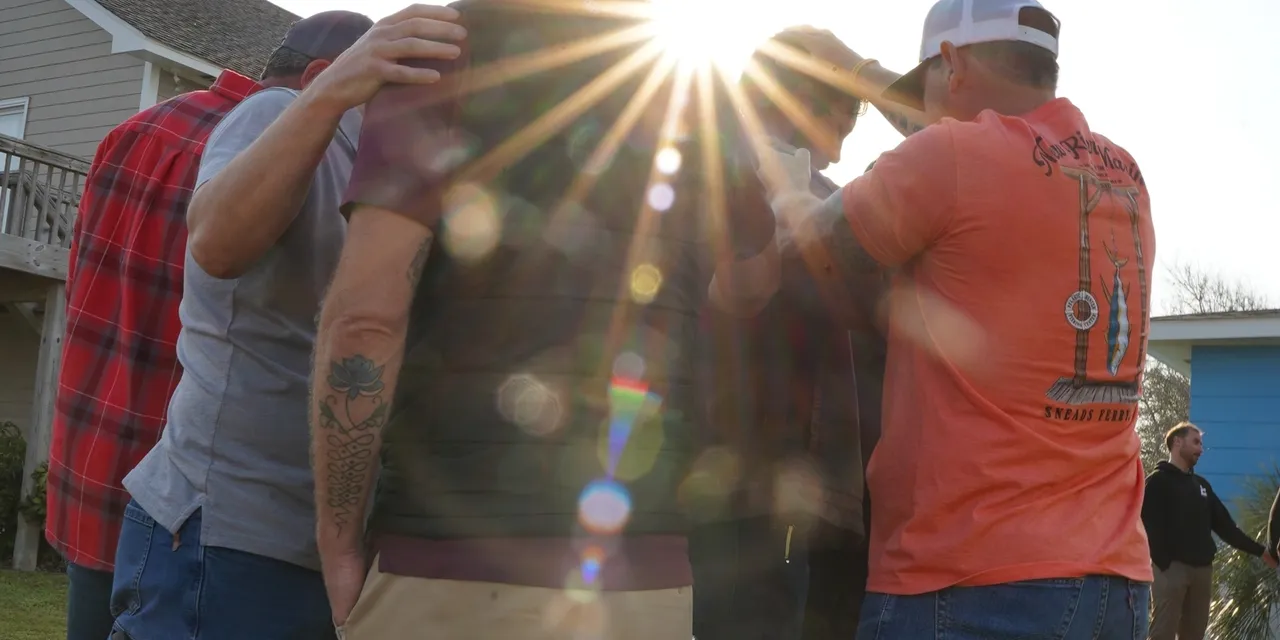 People embracing under bright sun rays