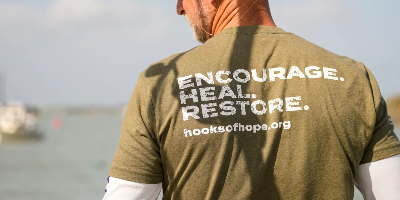 Green T-shirt promoting hooksofhope.org