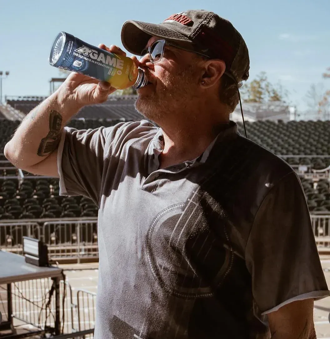 A man drinking from a bottle that says pepsi