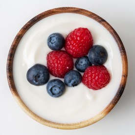 Top view of yogurt with raspberry and blueberry