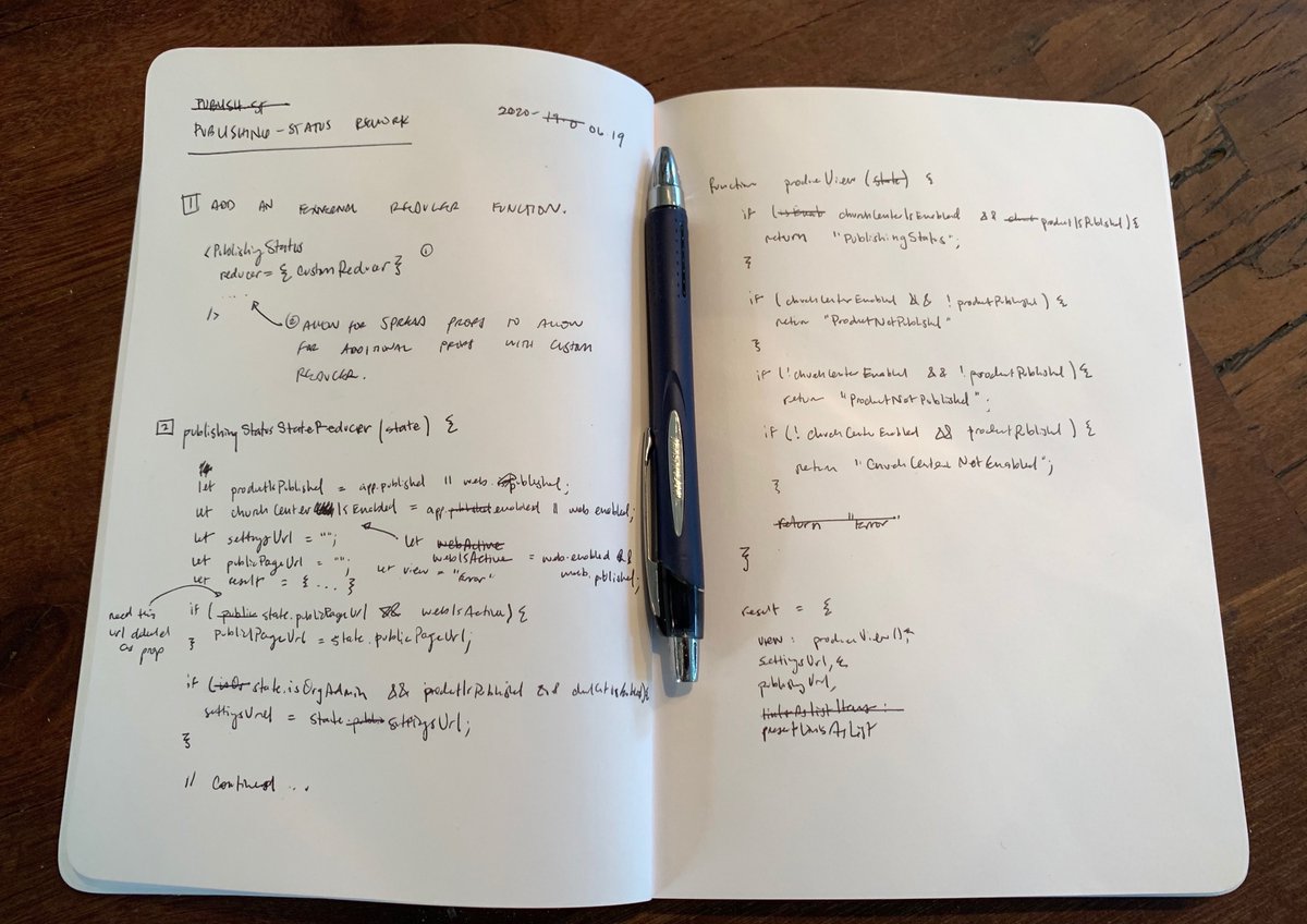 My notebook with a pen inside of it code written on the pages