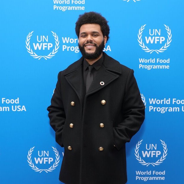 Photo of The Weeknd standing in front of United Nations World Food Programme banner.