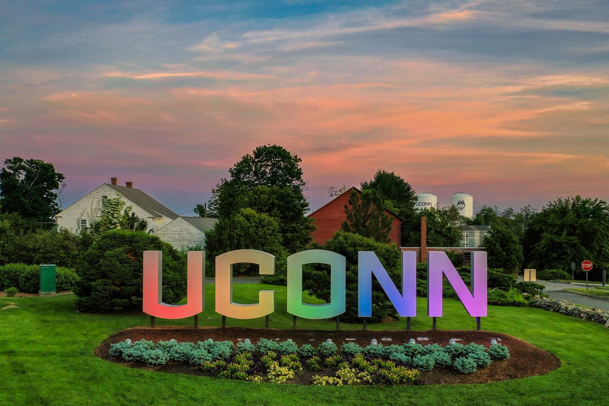 Giant U C O N N letters lit up in rainbow colors