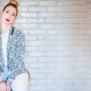 Lesley Logan, Pilates business/studio owner strikes a pose against a white wall
