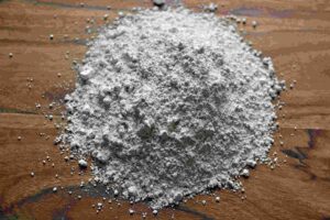 Powdered insecticide for bed bug treatment on wooden surface, emphasizing pest control preparation and application.
