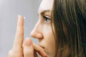 woman putting on a contact lens