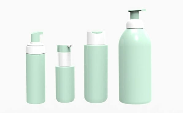 Four pastel green pump bottles of different sizes are lined up on a white background.