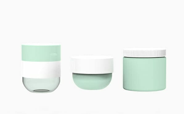 Three mint green cosmetic jars with white lids are shown on a plain white background.