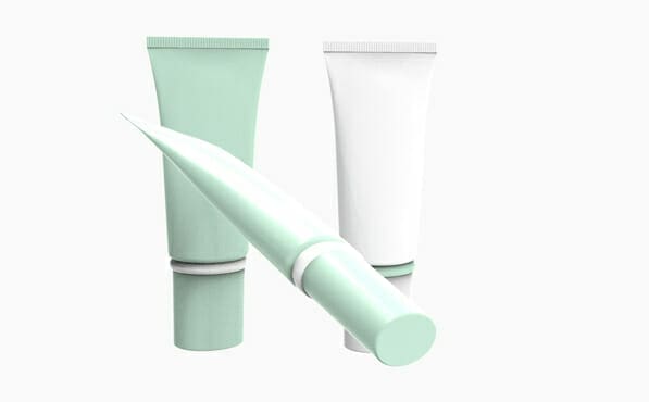 Three cosmetic tubes—two upright (mint green, white) and one mint green angled forward—on a white background.
