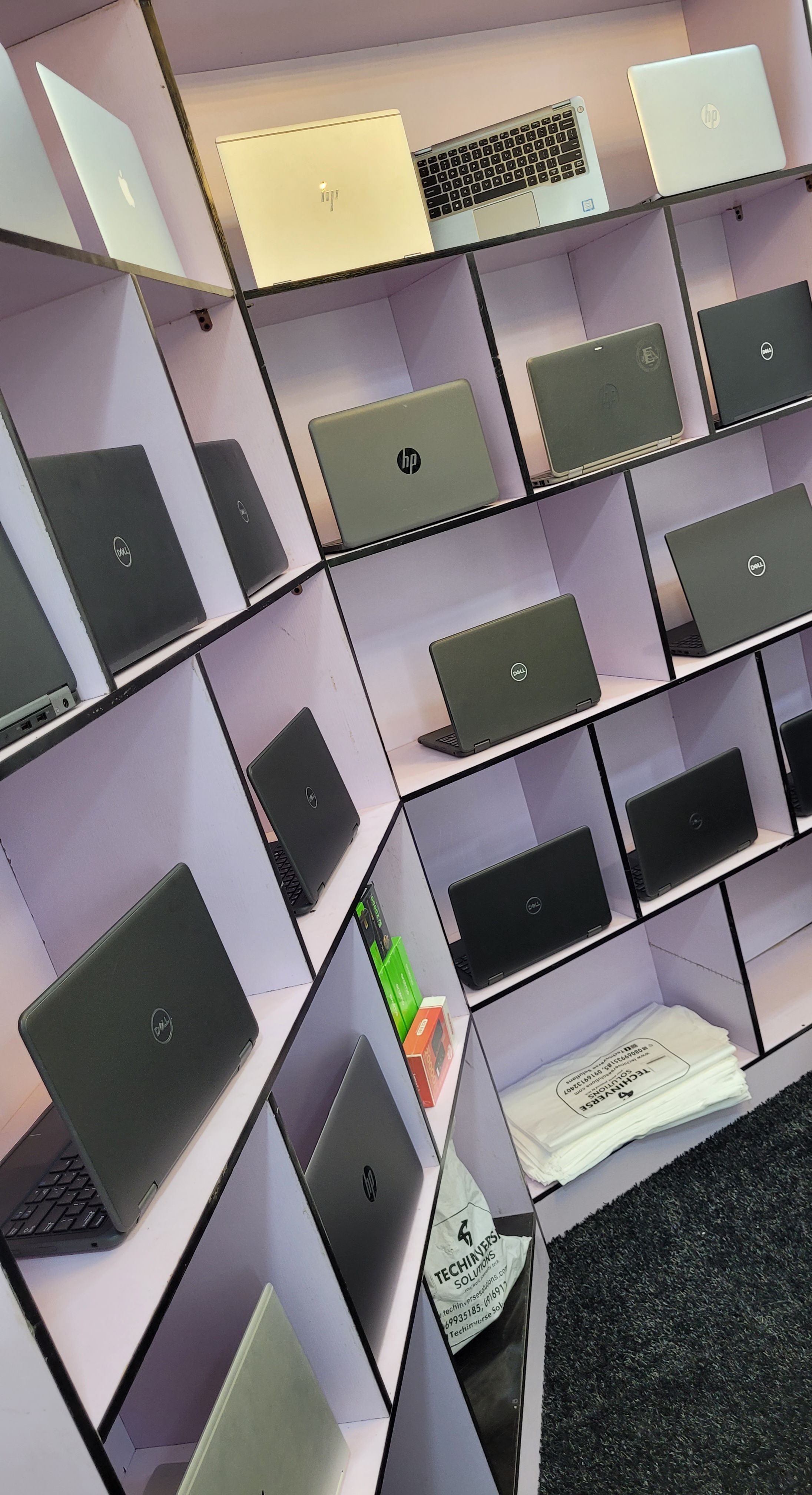 Premium technology products showcase including laptops, smartphones, and accessories on a clean modern background