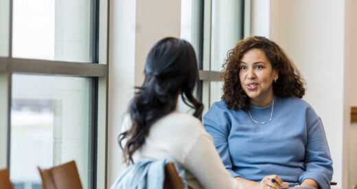 The female supervisor meets with her mid adult female employee to mentor her regarding a new position she is interested in within the company.