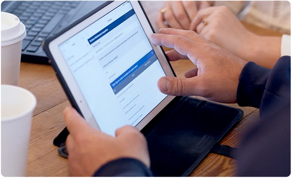 hands of people using a tablet