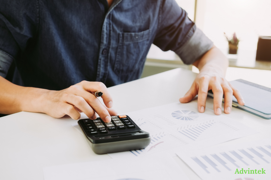 PINT AE Format Explained: The UAE’s Mandatory XML Invoice Standard 10 Finance professional reviewing reports with fta compliant invoicing software for PINT AE UAE e-invoicing compliance