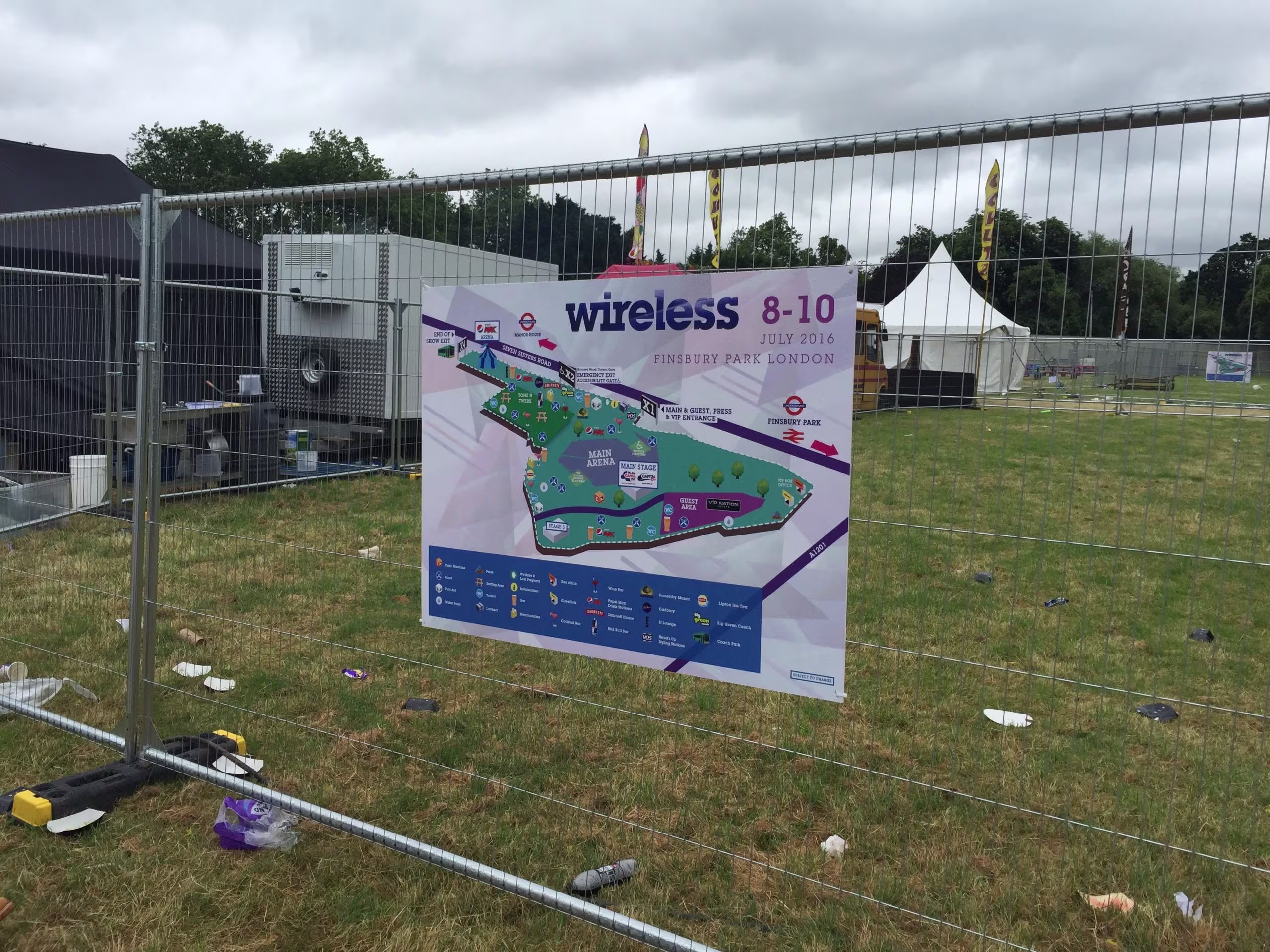 Outdoor event signage printed on banner mounted to temporary fencing