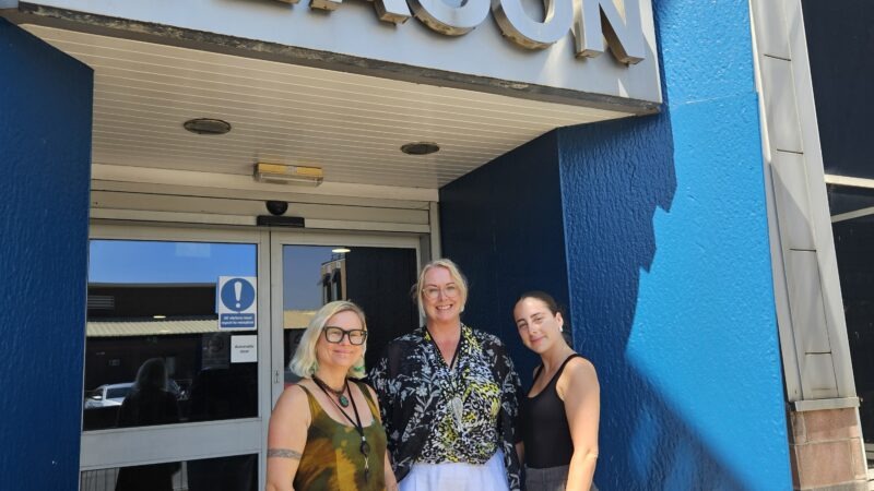Three women outside building