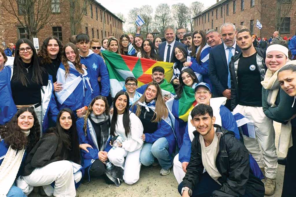 Israel’s Ministry of Education youth delegation, pictured with the Minister of Education, Yoav Kisch, all wrapped in Israeli and Druze flags.