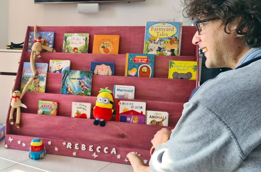 Locutus proudly showing the finished Montessori bookshelf to our daughter the day of her first birthday