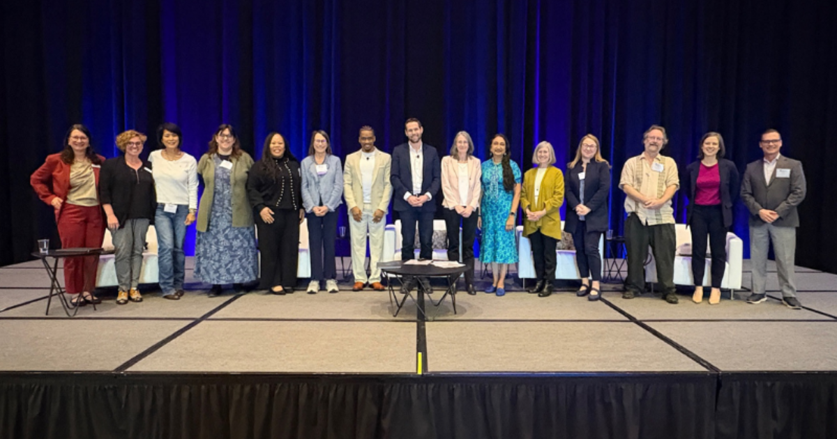 summit 2025 group photo on stage