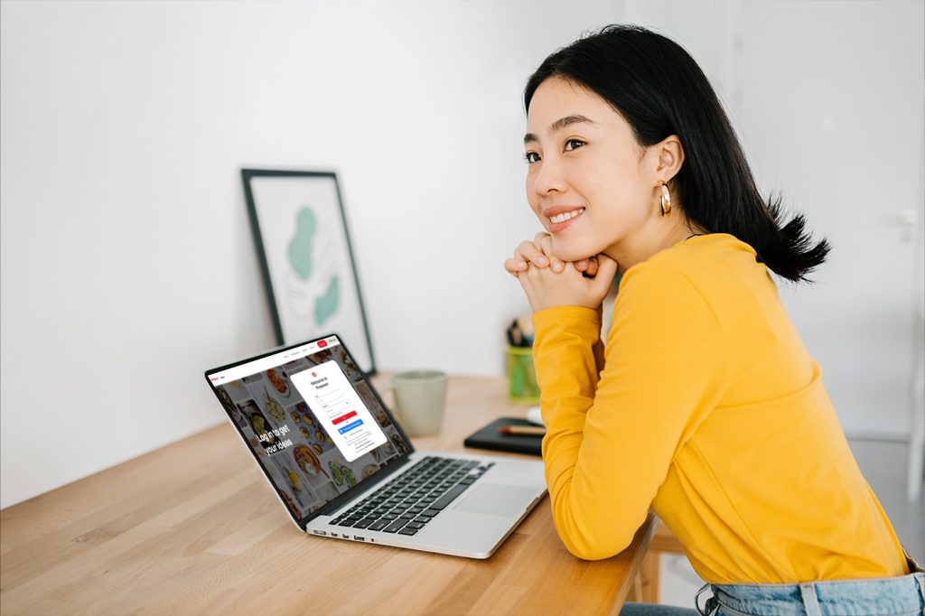 Woman About To Sign Up For Pinterest on Laptop.
